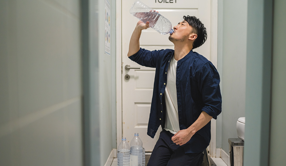 大量の水を飲む男性